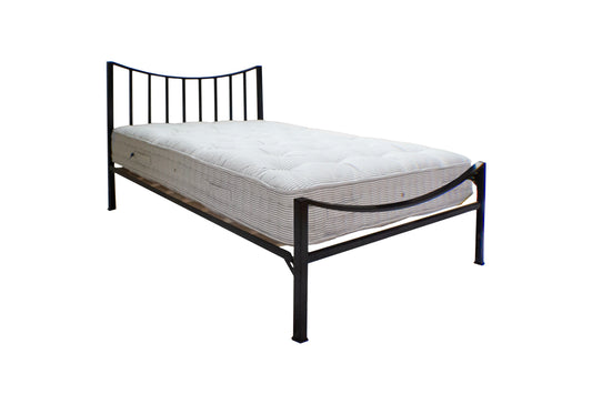 Black metal bed frame with mattress on a white background