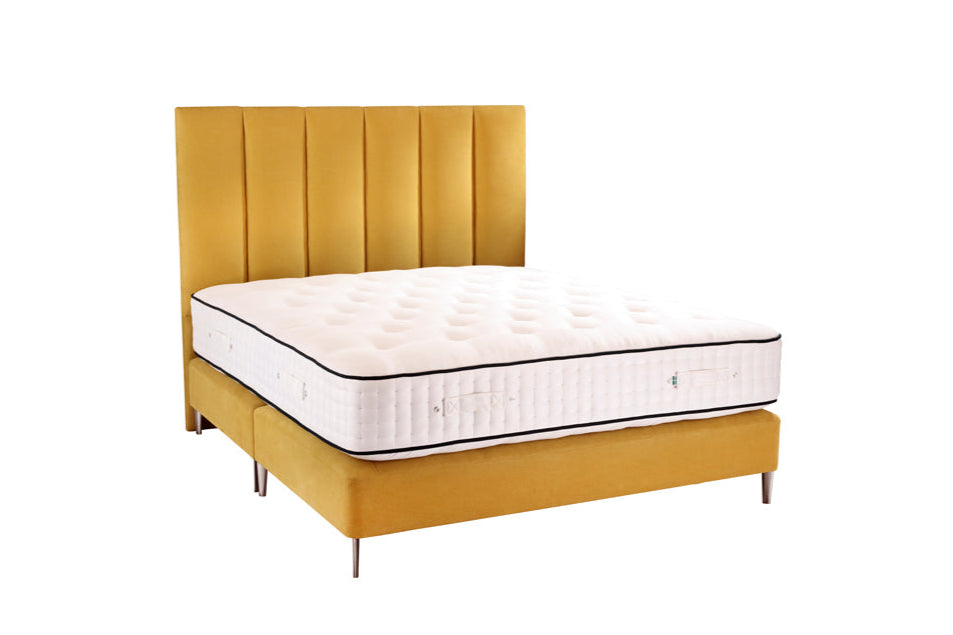 Yellow bed frame with a mattress on a white background