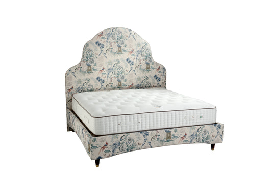 Floral-patterned bed with mattress on a white background